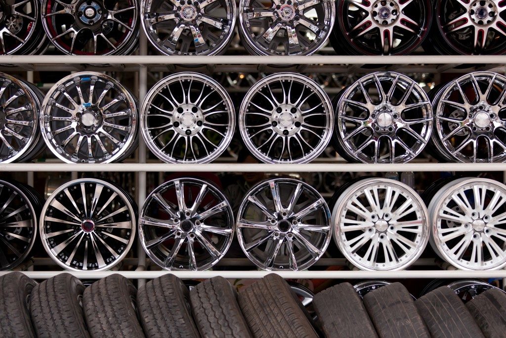 wall of alloy car wheels and pneumatic tires in store