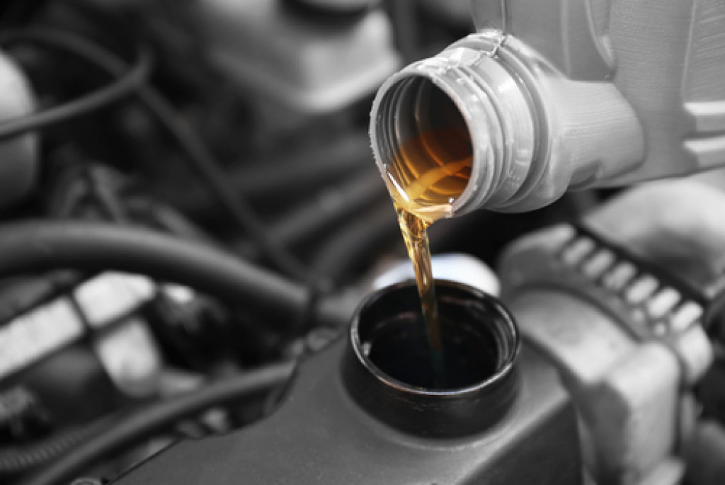 oil being poured into a service area of the engine