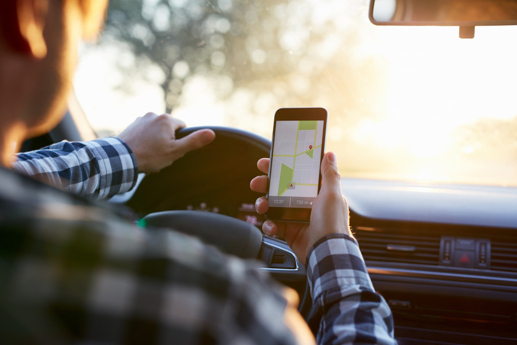 man driving using a gps tracker