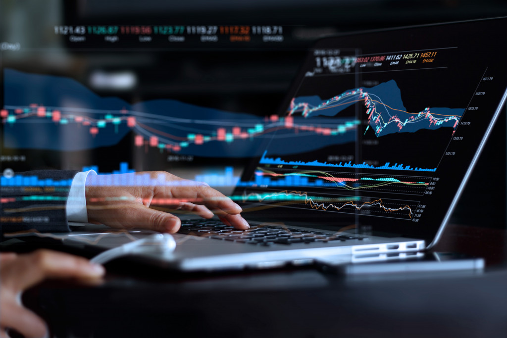 A businessman analyzing fluctuating graphs