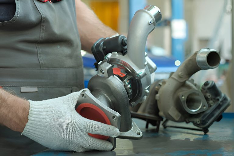 auto mechanic holding a turbocharger