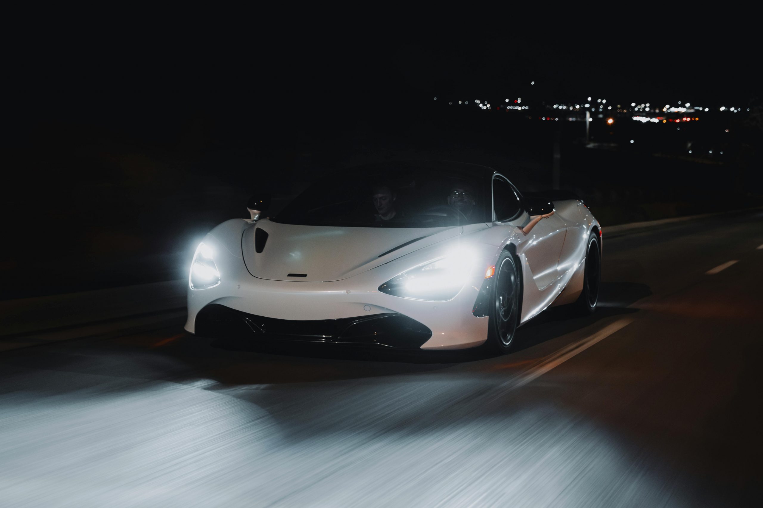 white sports car speeding on the road